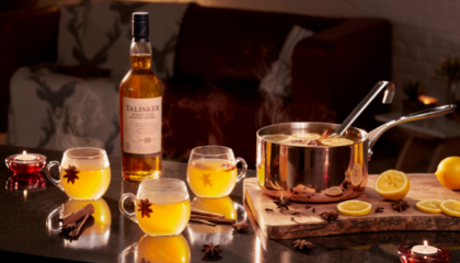 Talisker Hot Toddy served in glass with bottle of Talisker Whisky and large 
