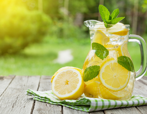   Glass Jug sitting on table with lemon  