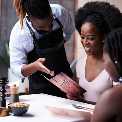 Bartender serving customer menu