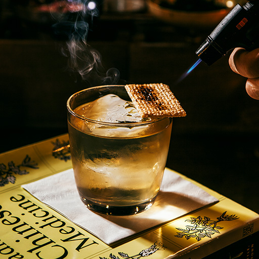 Blowtorch caramelising garnish on top of Tokyo drift cocktail in Keefers Bar