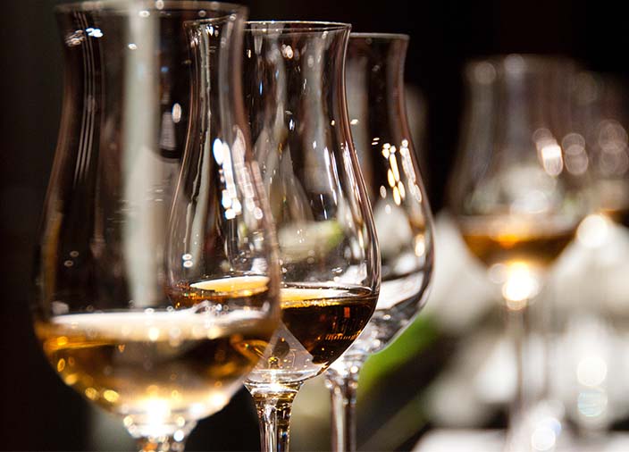 Close up image of whisky glasses with whisky in them