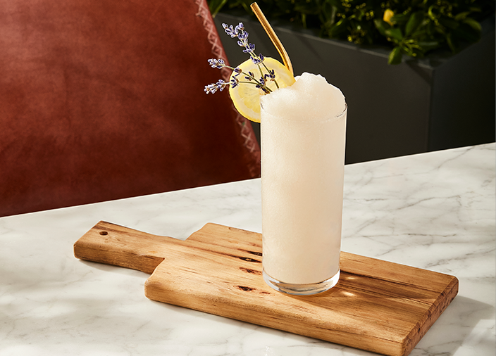 Frozen cocktail in a glass on a cutting board