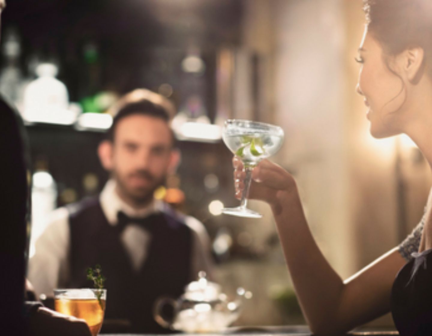 Woman holding a cocktail at the bar