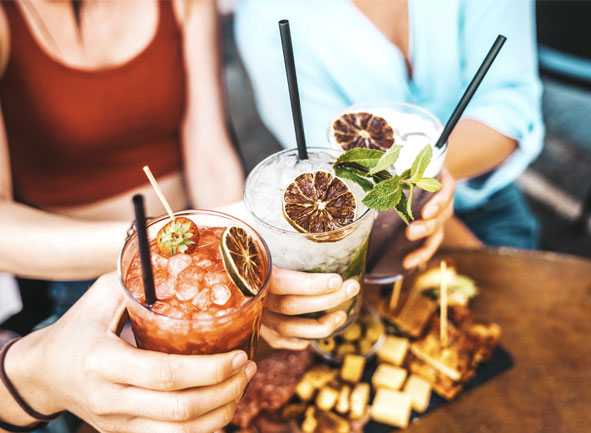 3 people holding cocktails 