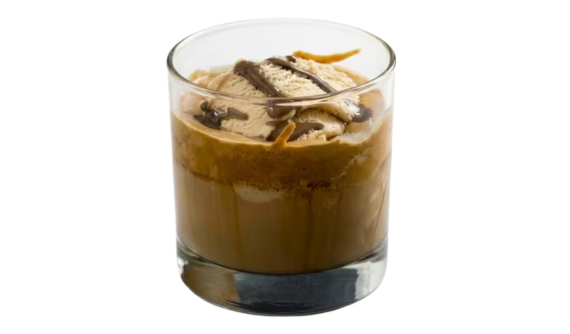 Copo baixo contendo uma bebida cremosa em tom marrom. O topo traz uma generosa bola de sorvete claro, finalizada com fios de calda escura de chocolate em zigue-zague. Fundo branco isolado.