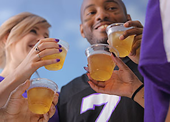 Friends cheering at a football game 