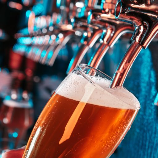   Cold glass of beer being poured in a bar  