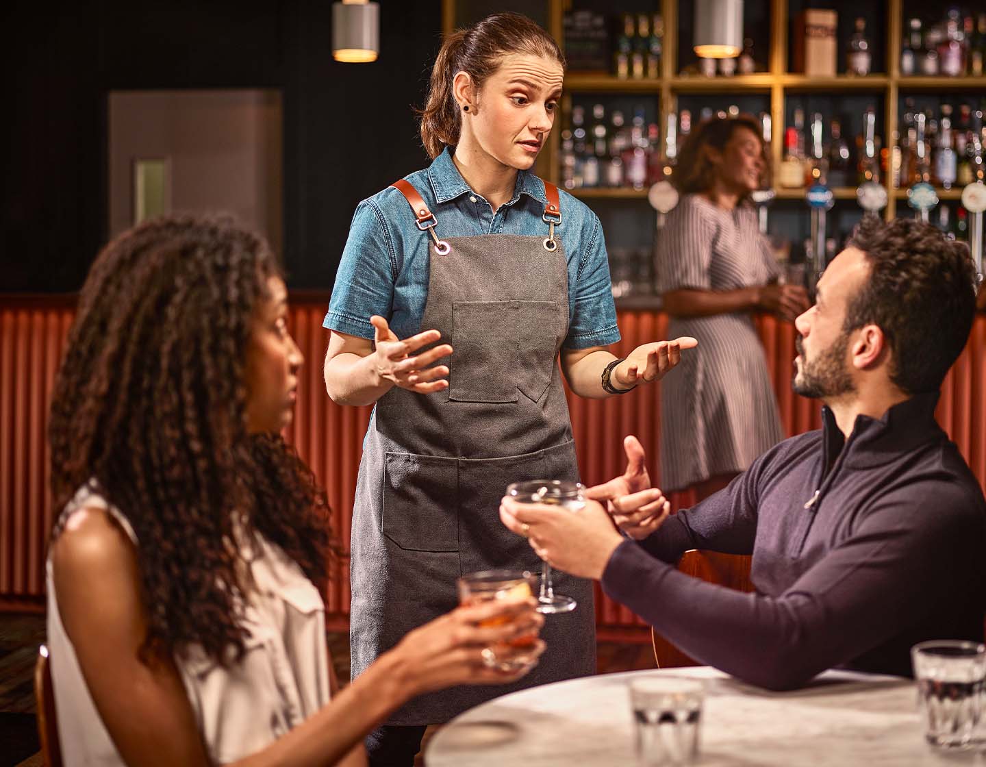  A bar staff member dealing with a customer complaint 