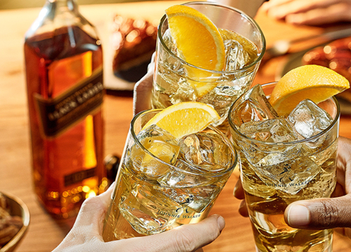Three highball glasses clinking to ‘cheers’