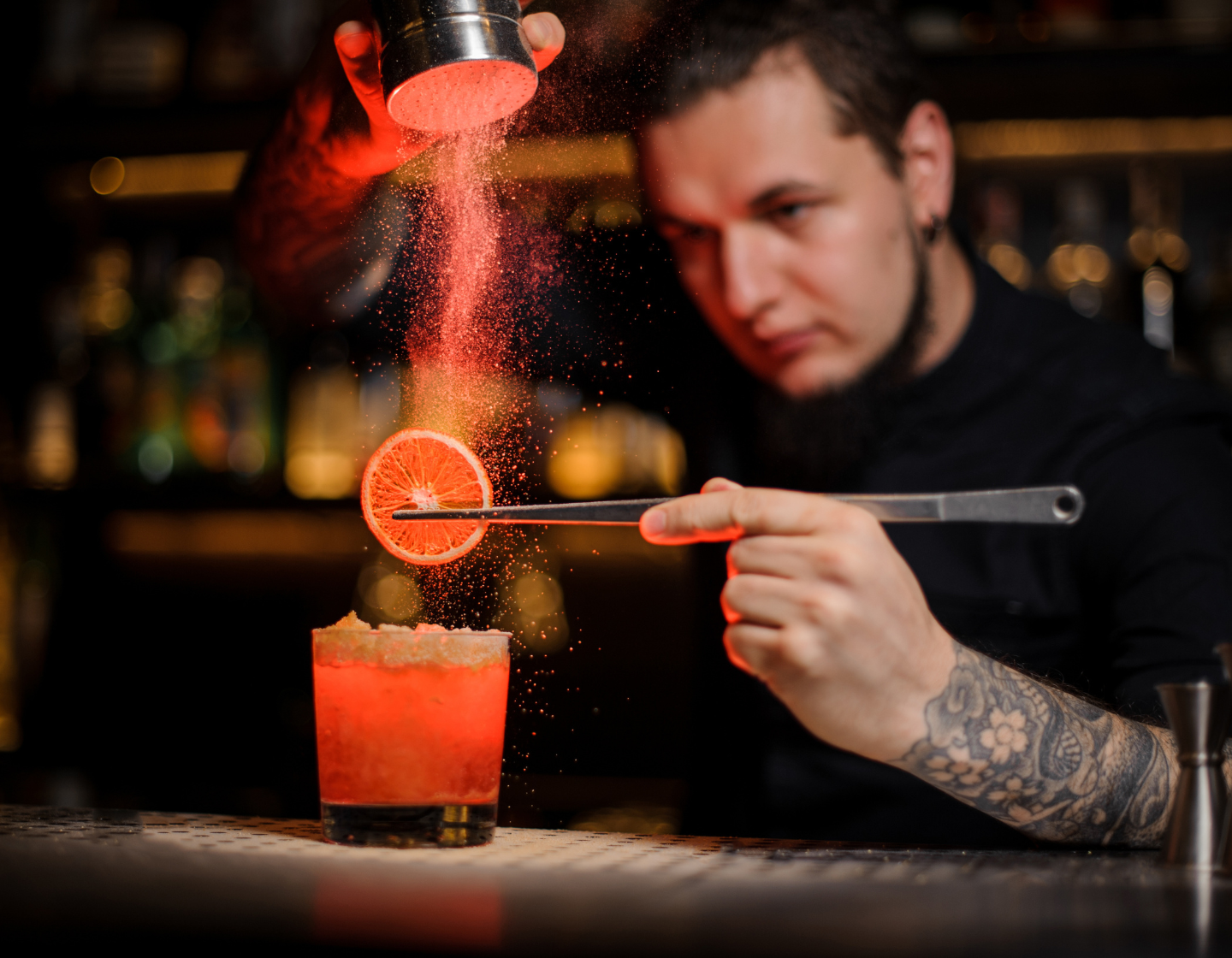 Rum cocktails on table with bar tools behind