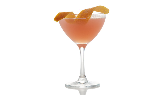 Cocktail in a copue glass with orange twist garnish