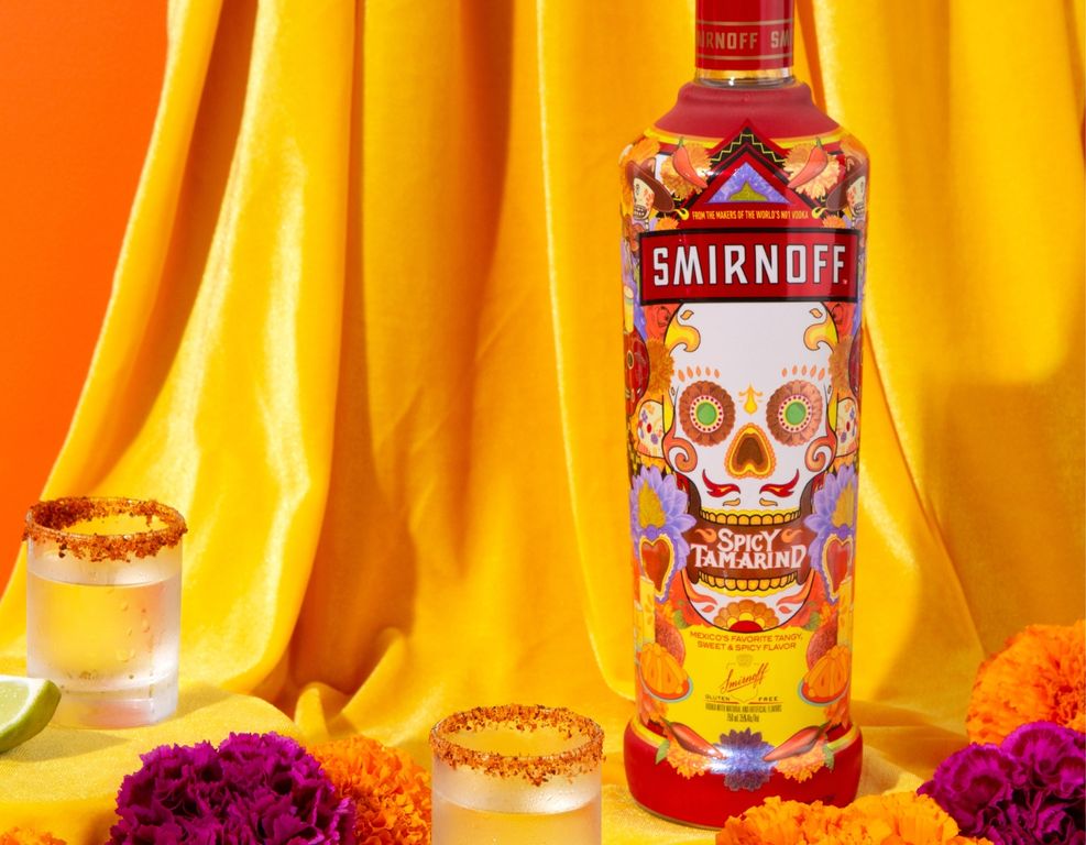 Woman pouring a bottle of Smirnoff Spicy Tamarind into a jigger