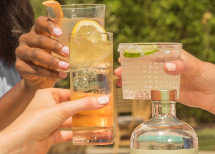 Three drinks in hands
