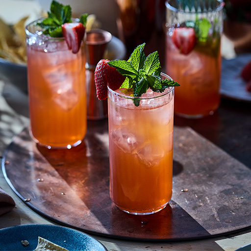 Cocktails in tall glasses with fancy garnish