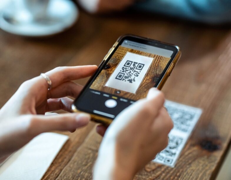 Person scanning QR code menu