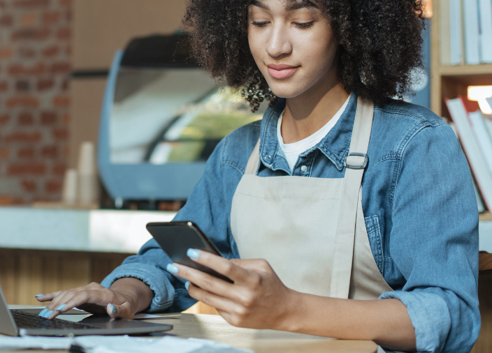 Woman on phone and laptop