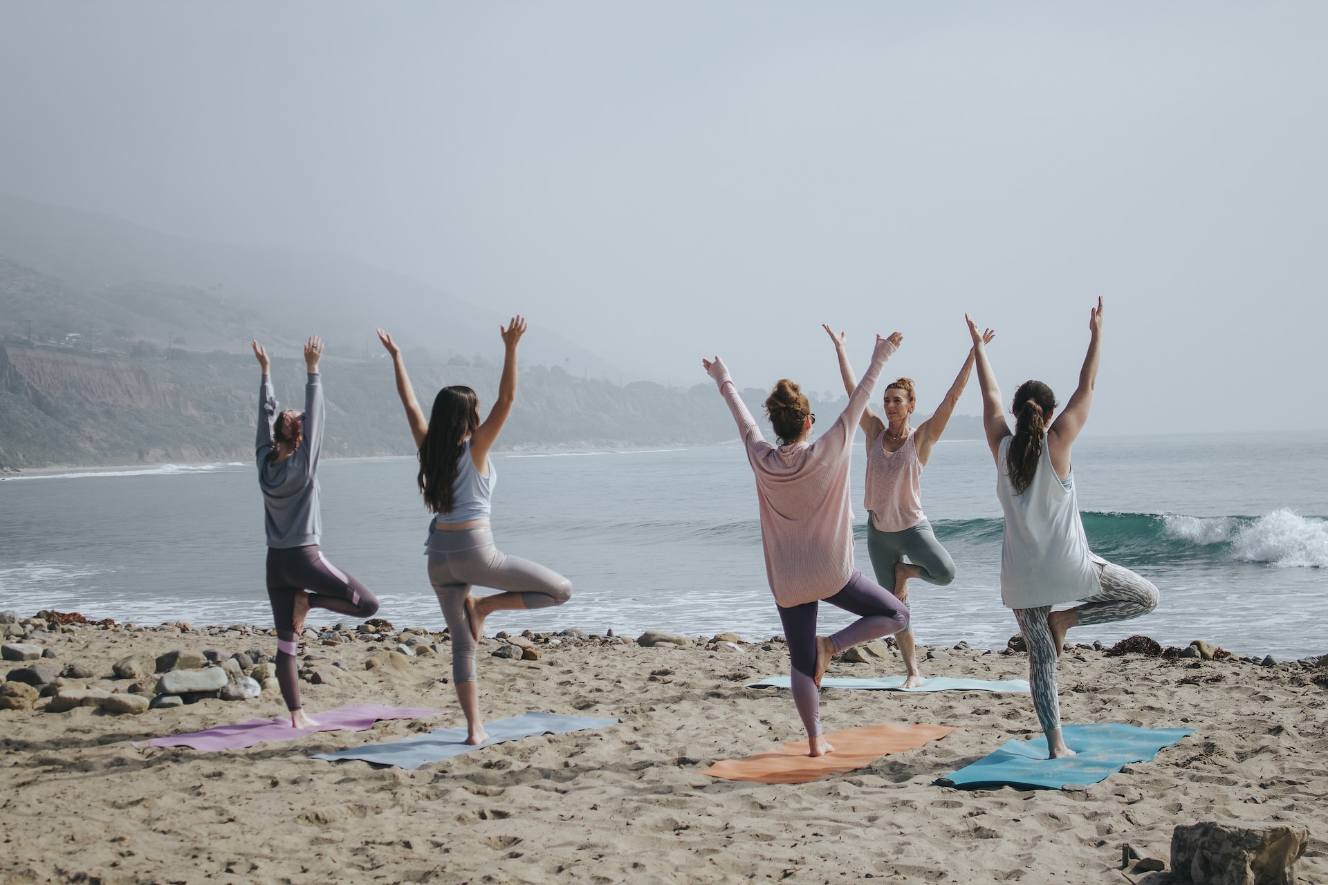 practicing yoga on the beach 