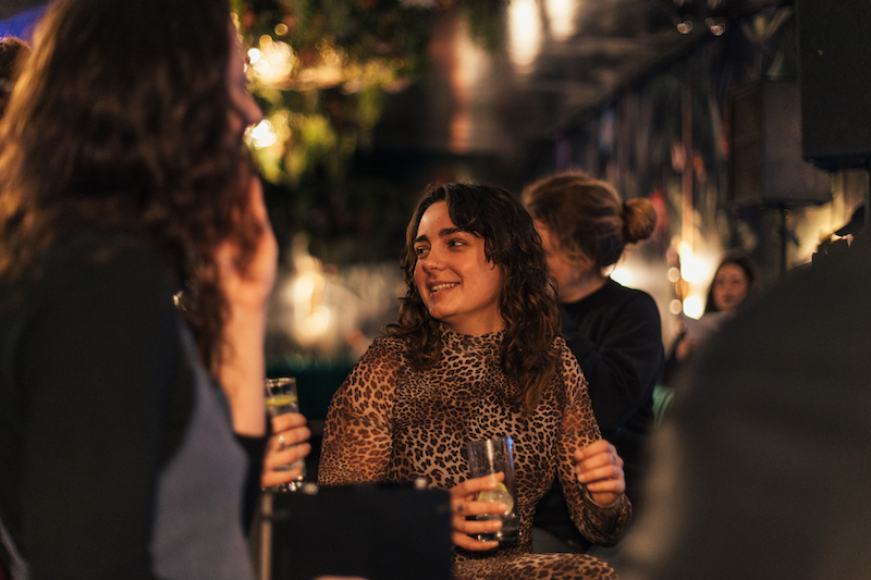 Eine Barkeeperin auf dem World Bartender Day hält einen Drink in der Hand