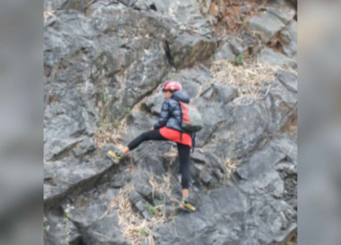 A person rockclimbing outside