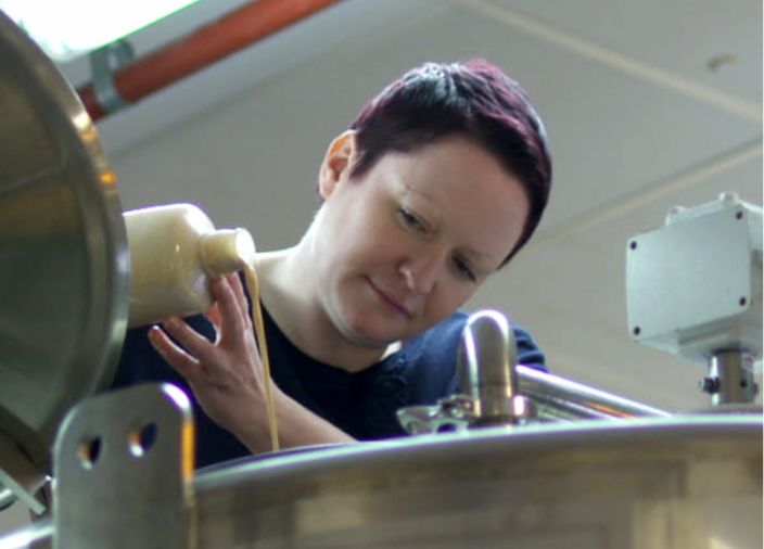 Dr Emma Walker at a machine in the whisky making process 