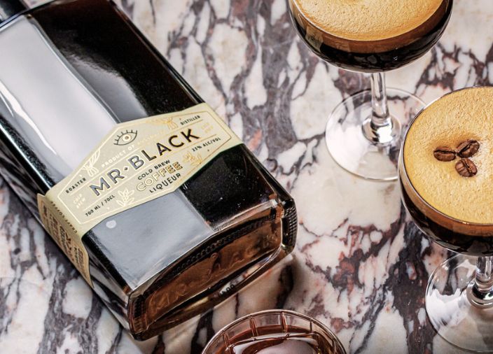 Bottle of Mr Black with two espresso martinis.