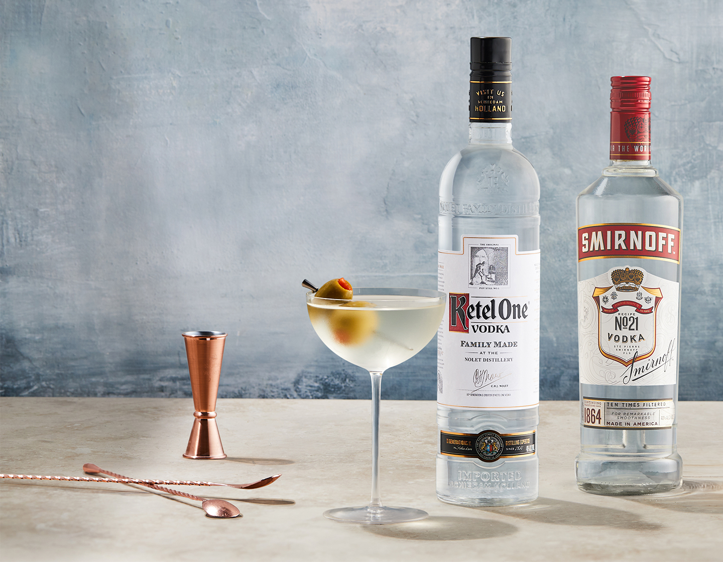 vodka cocktail beside bottle of smirnoff and ketel one