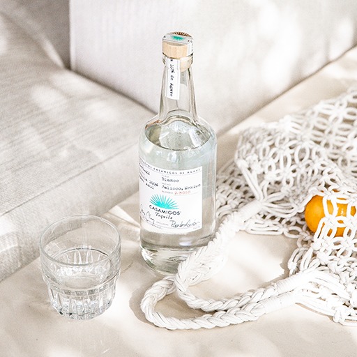 Cocktail bottle with glass on table