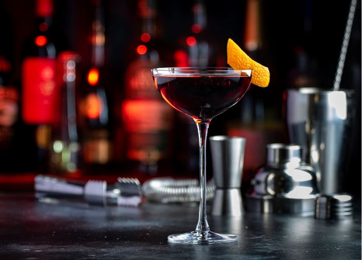 Whisky, bitters, vermouth cocktail with orange peel garnish 