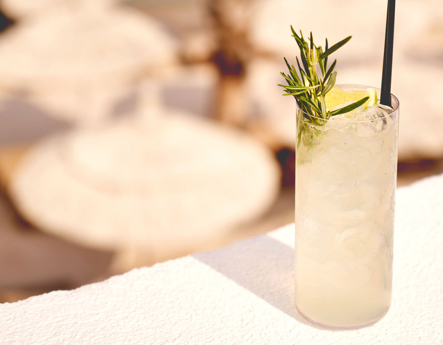 Single cocktail glass sitting on a white wall 