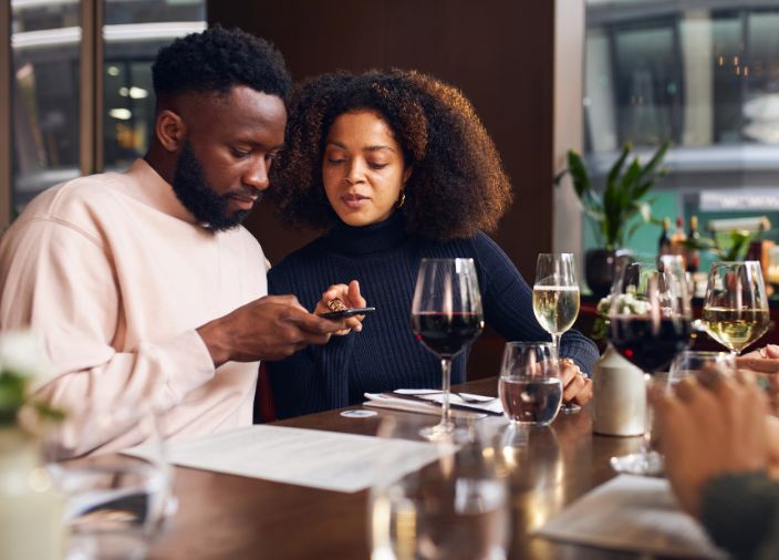 Customer looking at bar menu on their phone by using QR code