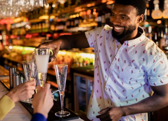 Bartender pouring champagne at the bar