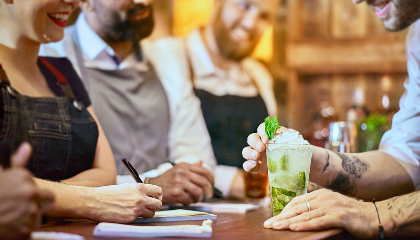 Bartenders at the bar interacting 