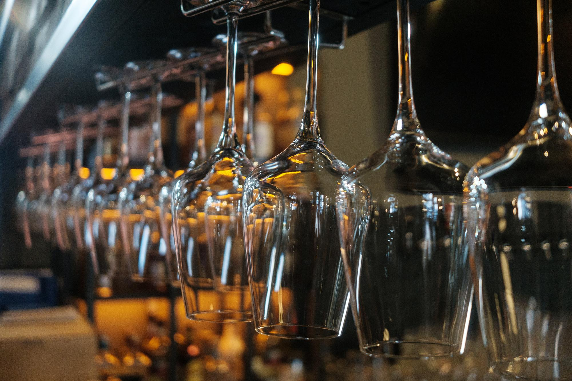 A collection of wine glasses on a counter top 