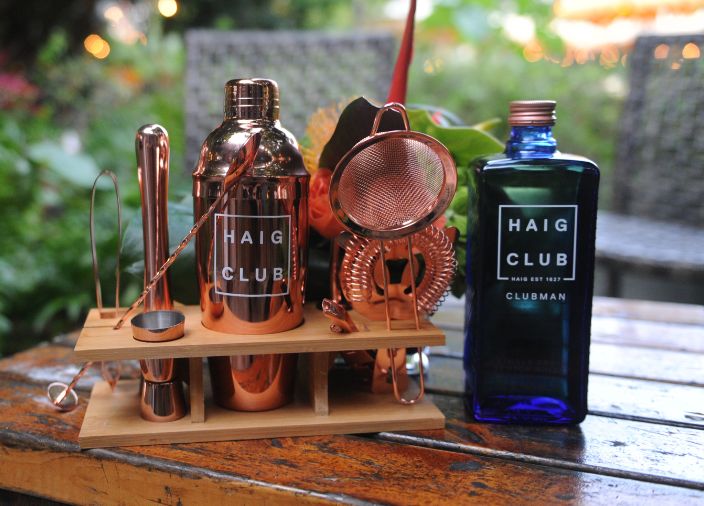 Haig club clubman bottle beside cocktail tools