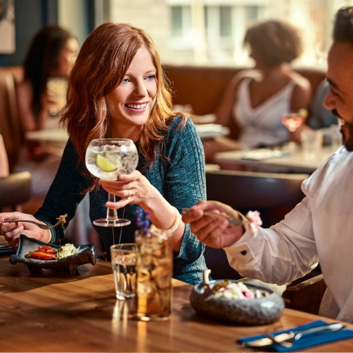 Couple enjoying food and cocktails