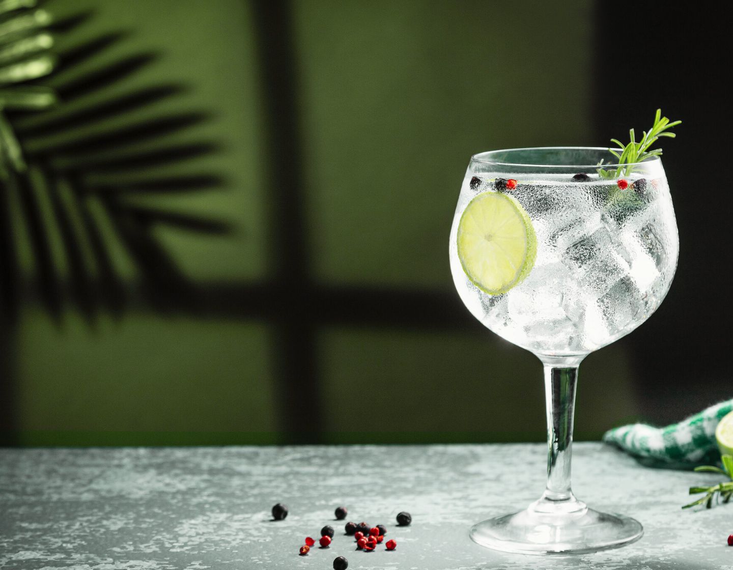 Gin and Tonic, garnished a gin goblet. 