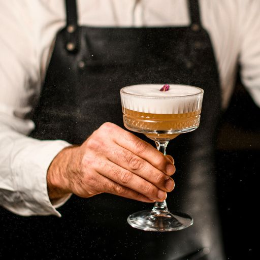 Bartender Holding Cocktail With Garnish 