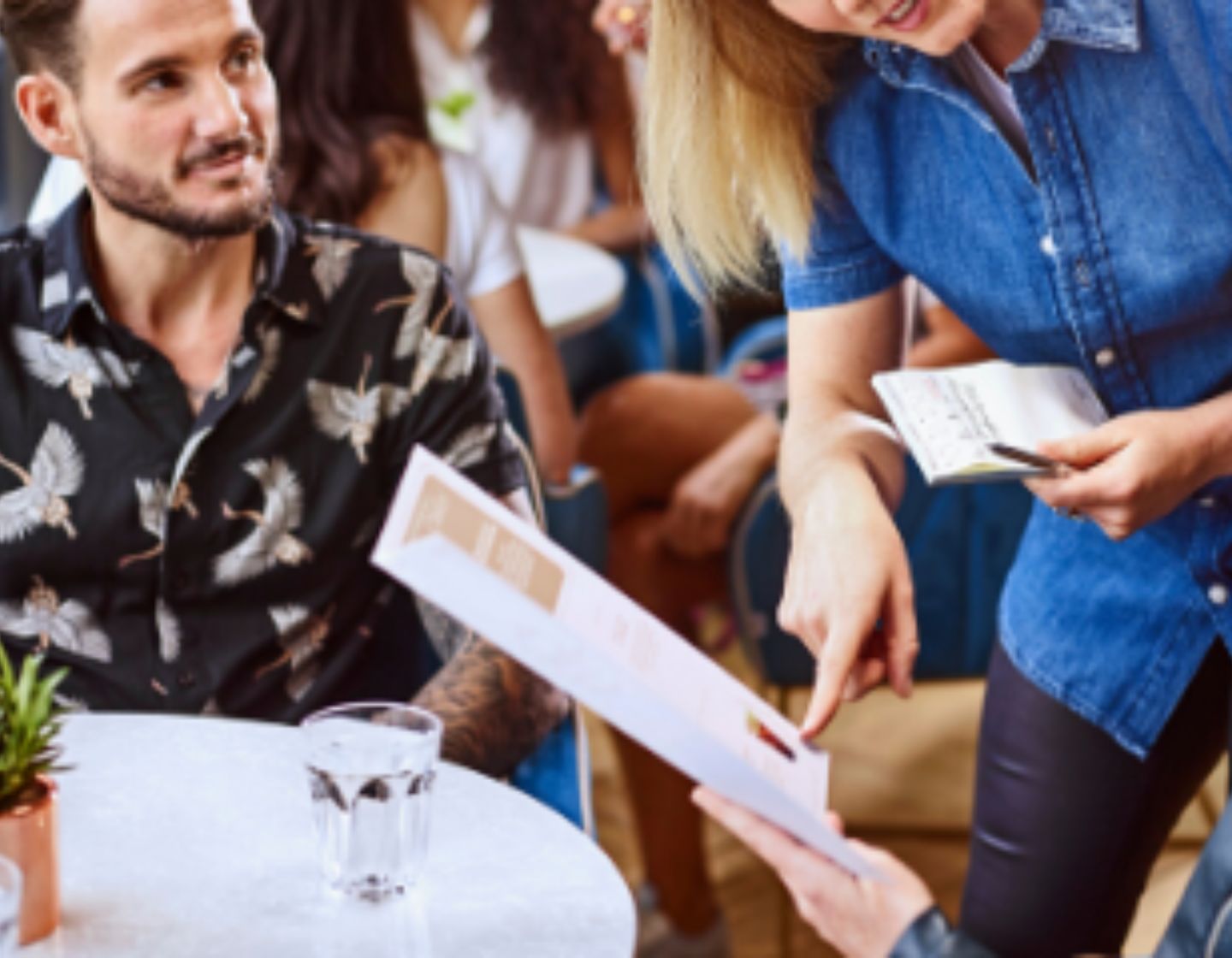  Bartender showing customer a menu 