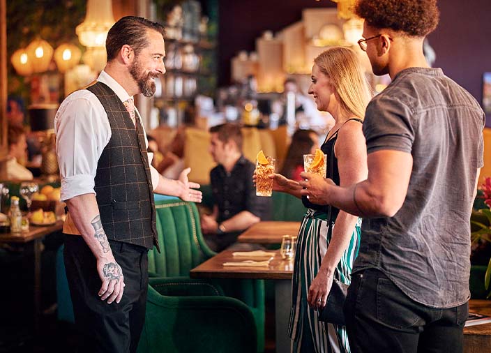 A staff member speaking to two customers 