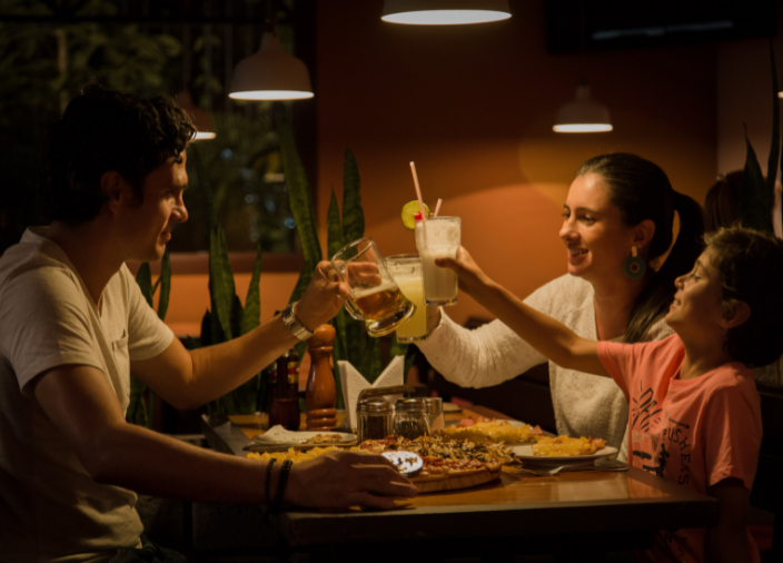 Hand holding a cocktail at table