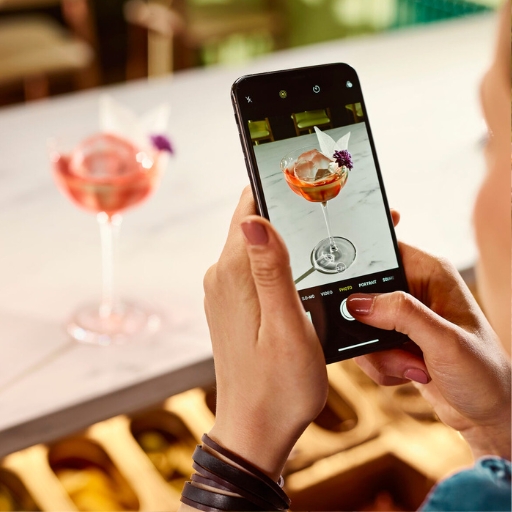 Customer taking photo of trendy cocktail