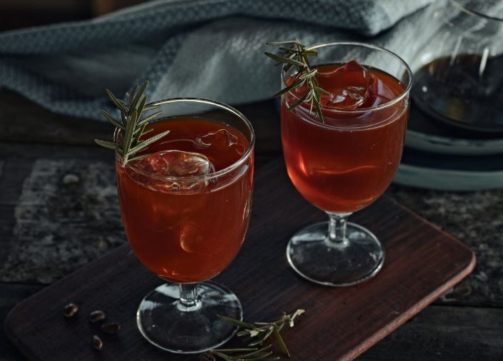 Two Blood and San cocktails with rosemary garnish