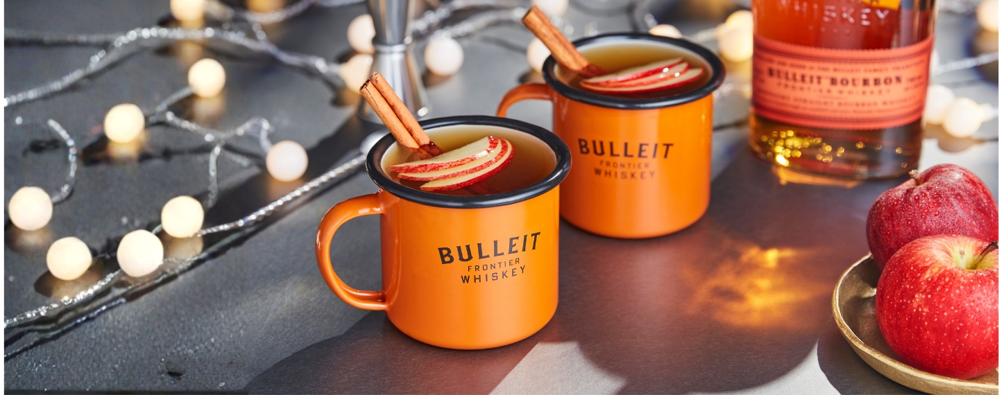 warm cocktails with apple garnish