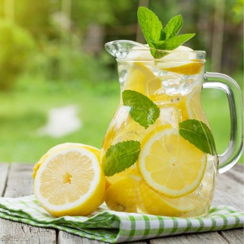   Glass Jug sitting on table with lemon  