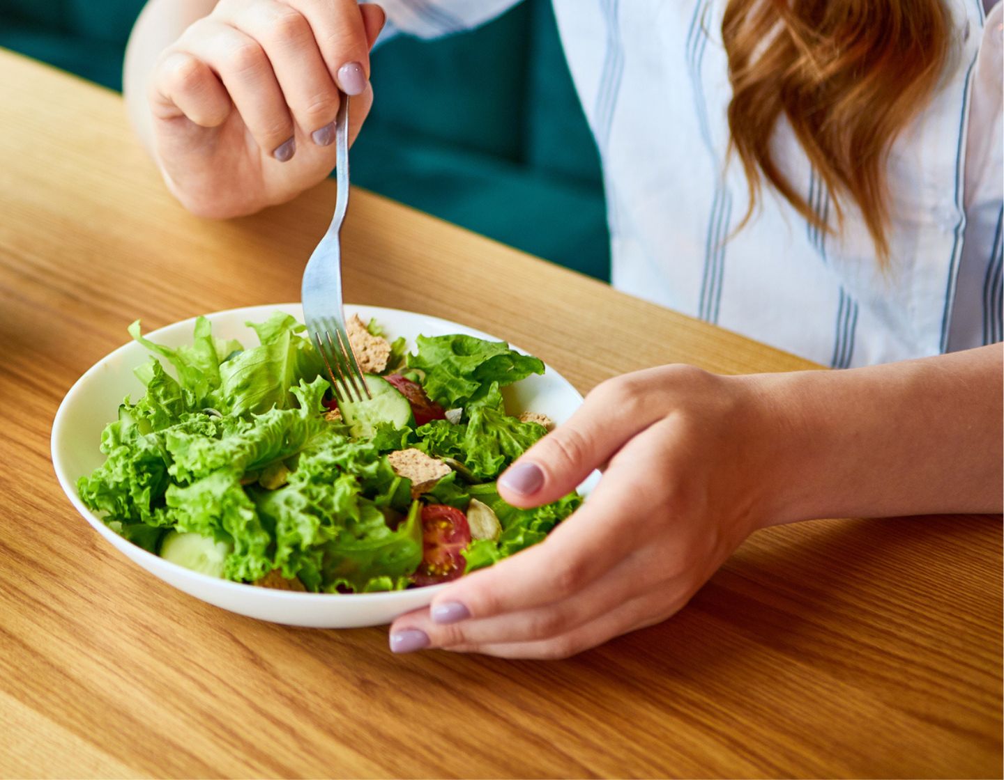Woman eating a salad taking a break from a long shift