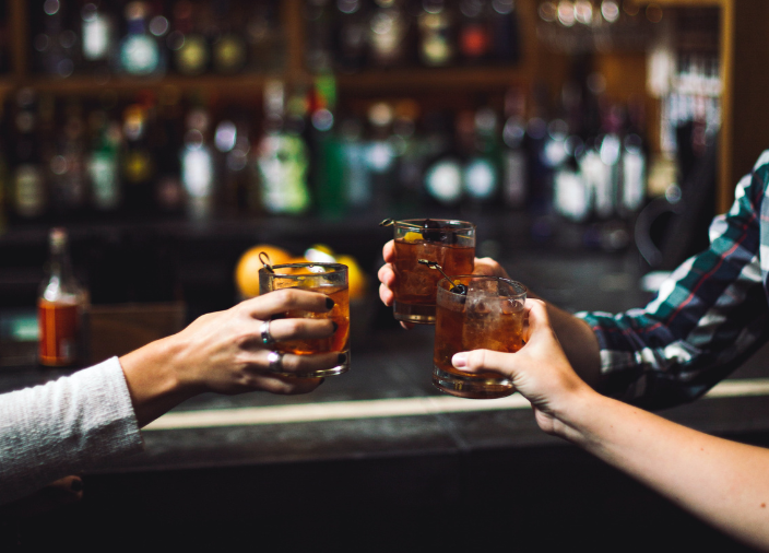 Group of people raising glasses in a toast 