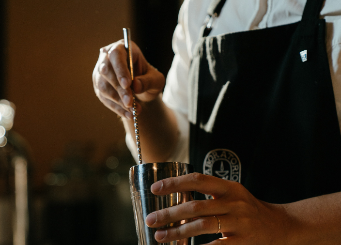 Hand stirring spoon in tumbler