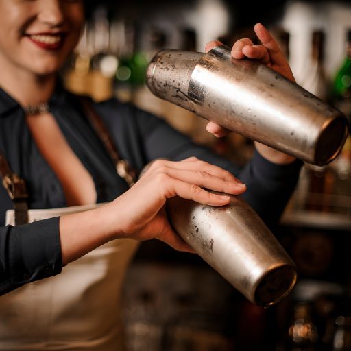  Bartender shaking two cocktail shakers 