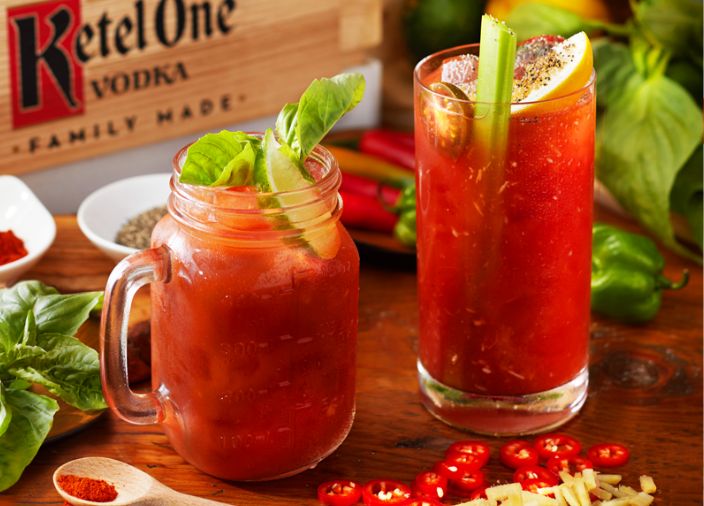 2 Bloody Mary cocktails in glasses with garnish and Ketel One branded box behind them