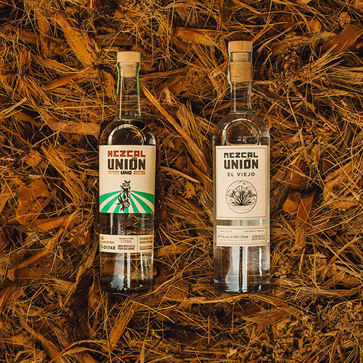 Mezcal Unión bottles on a barrel